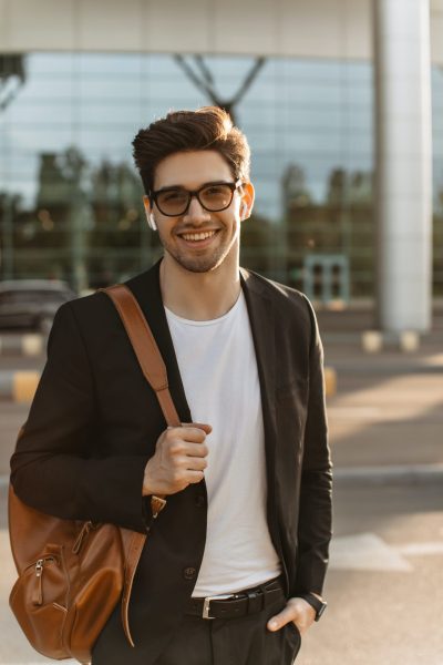 happy-businessman-in-eyeglasses-looks-into-camera-and-smiles-sincerely-brunette-guy-in-black-jacke.jpg